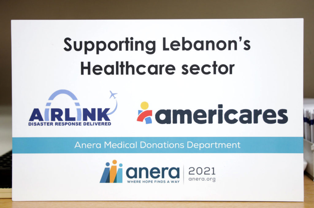 Sign noting Anera's partnership with Americares and Airlink