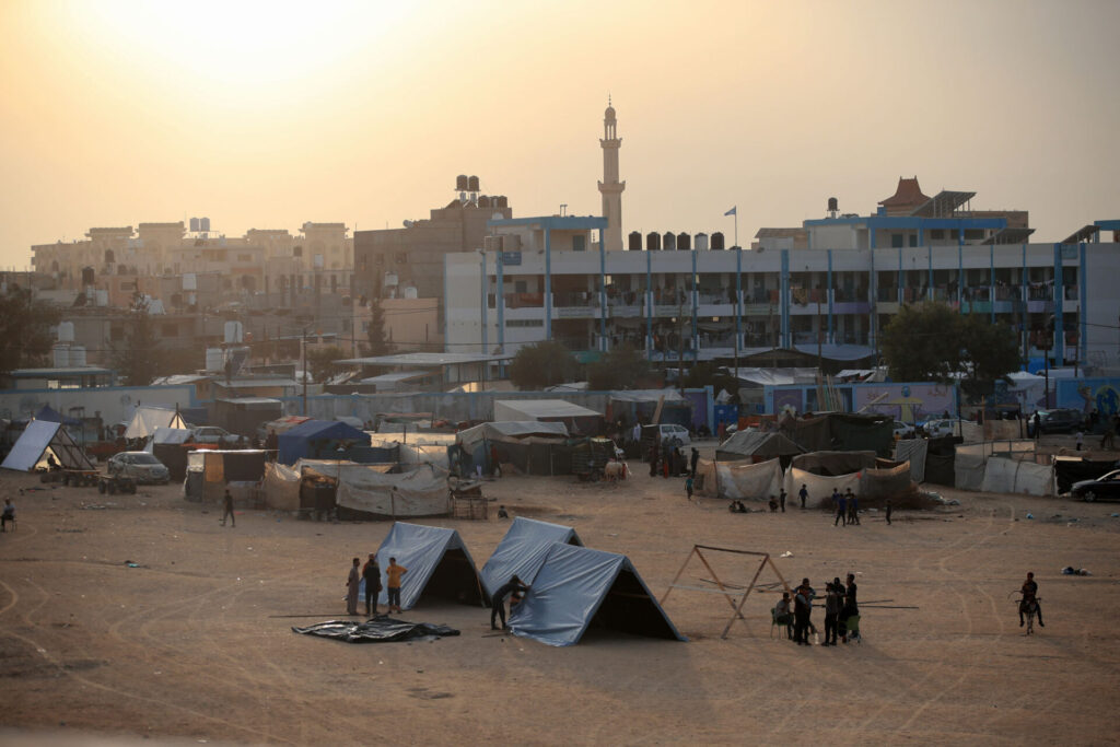 The sun sets over a camp.