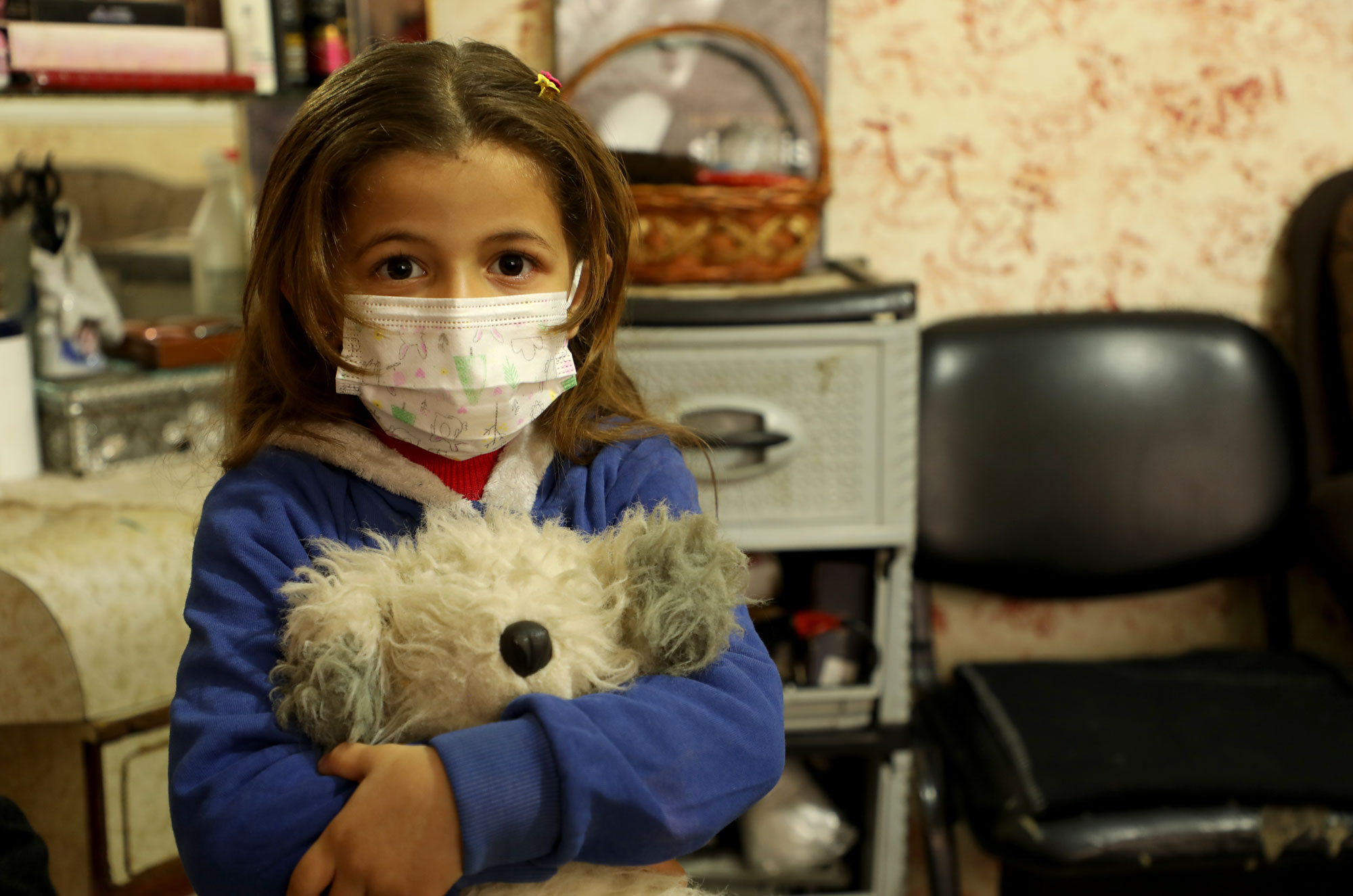 gaza, water, wash, sabra, niven's daughter Young girl holds a stuffed animal