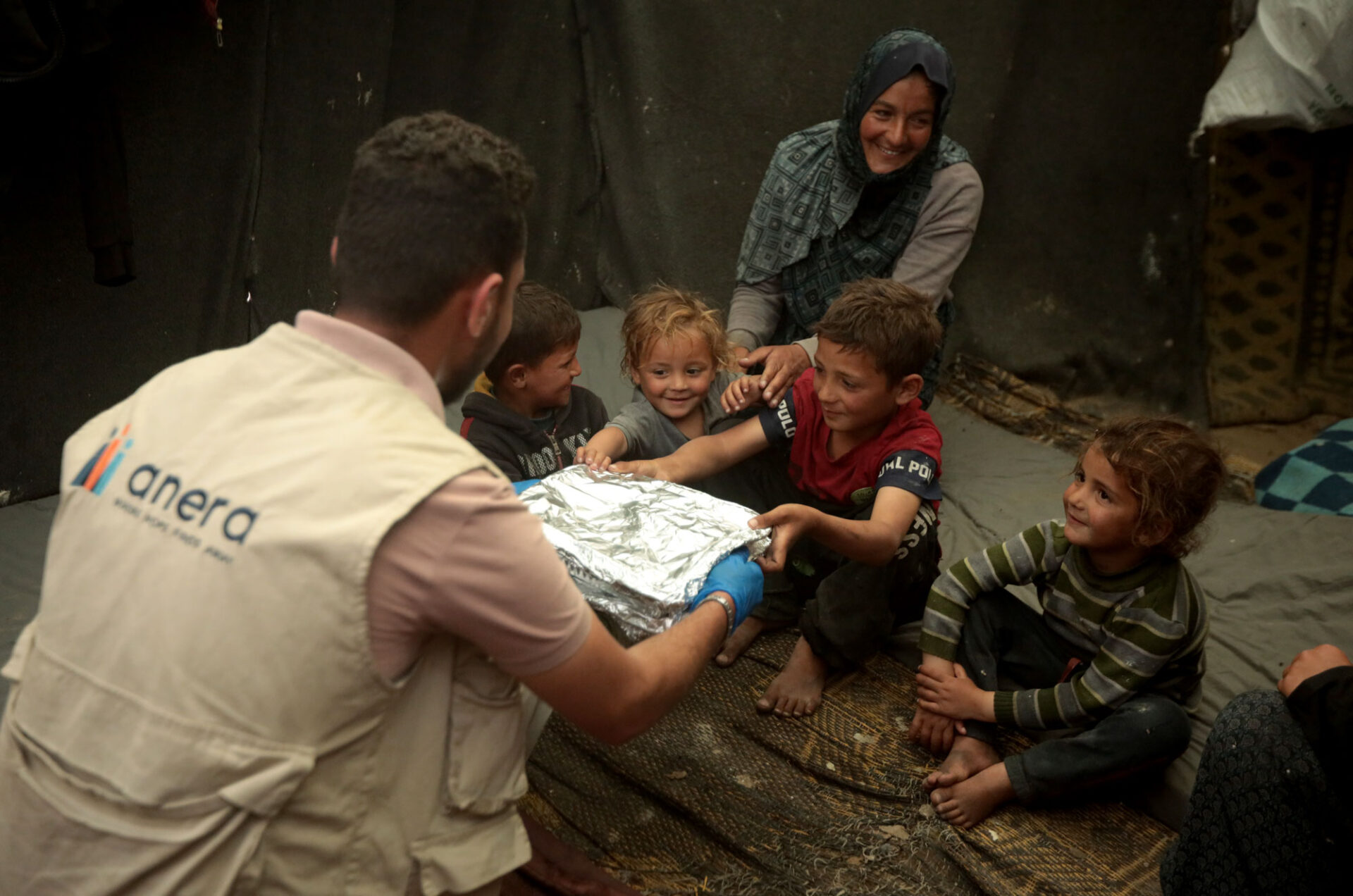 Hot meals are delivered to a displaced Palestinian family in Gaza. | March 31, 2024.