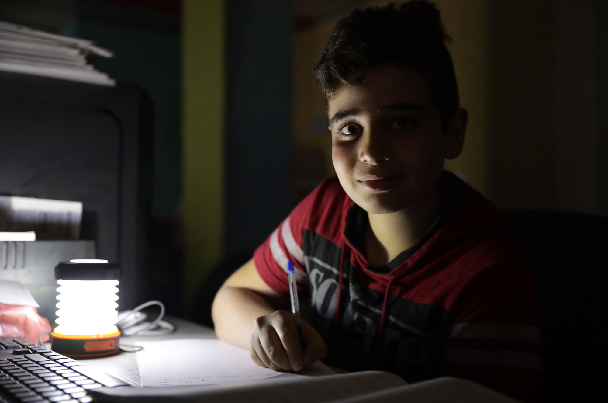 Using a portable light to study in Beirut.
