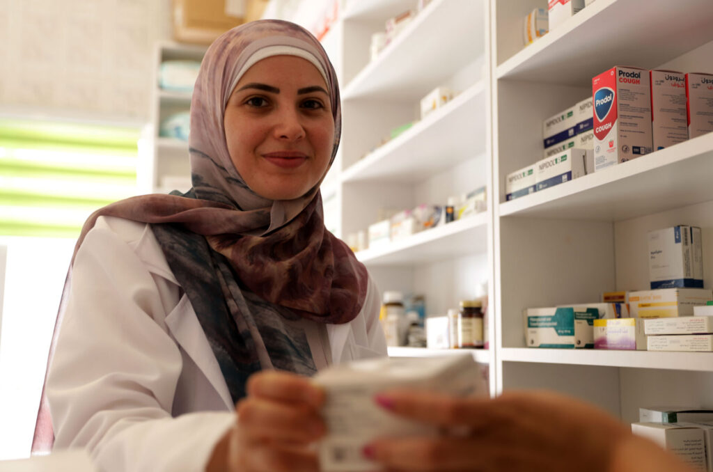 Alaa the pharmacist dispenses medicines.