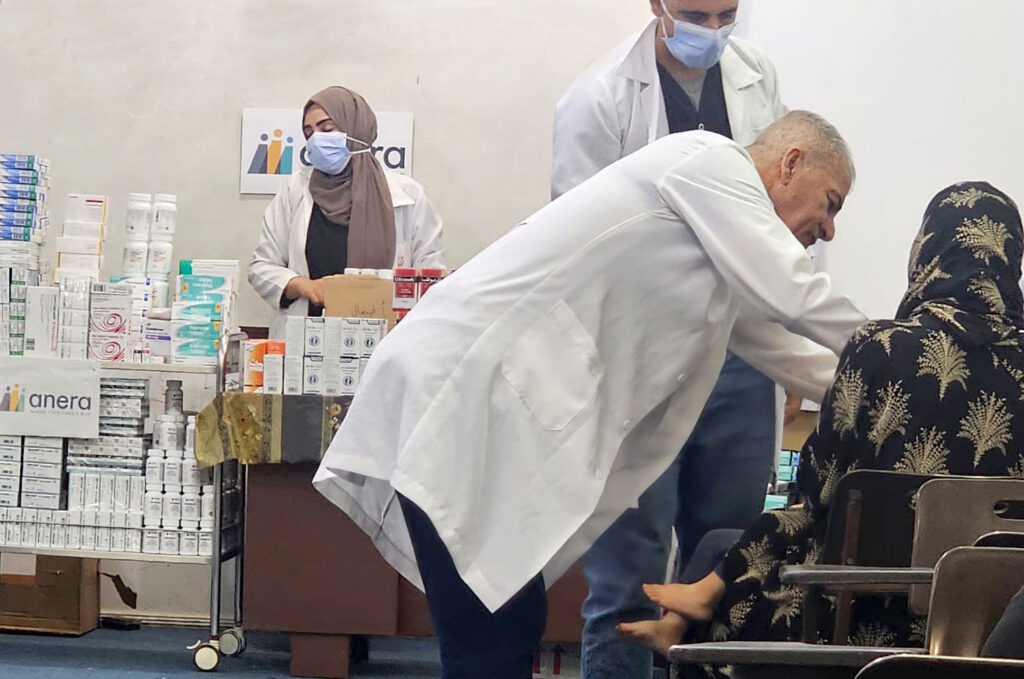 Three healthcare providers and a patient at the open healthcare clinic.