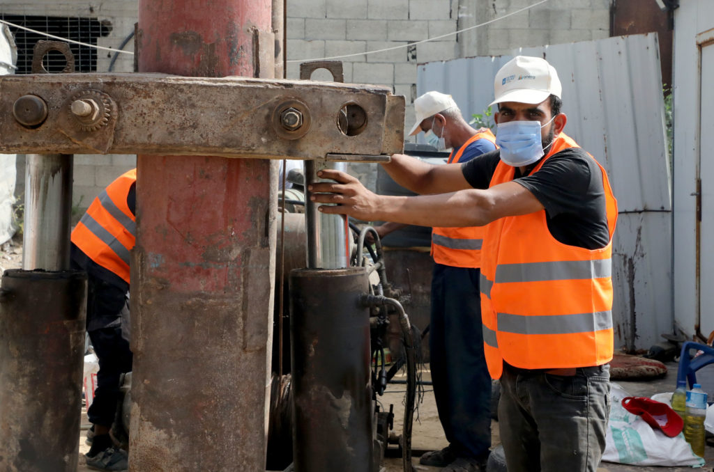 Workers in Mughraqa, Gaza on the construction site of the water well.