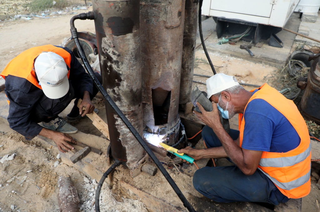 Workers do some welding in Mughraqa, Gaza on the construction site of the water well.