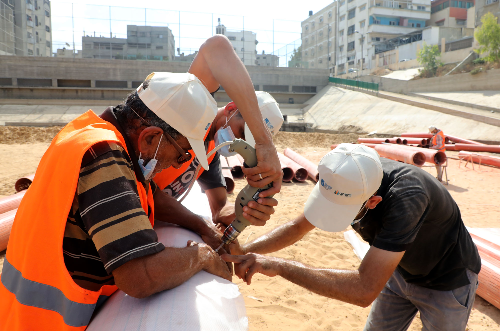 Workers drill into a segment of the pipeline.