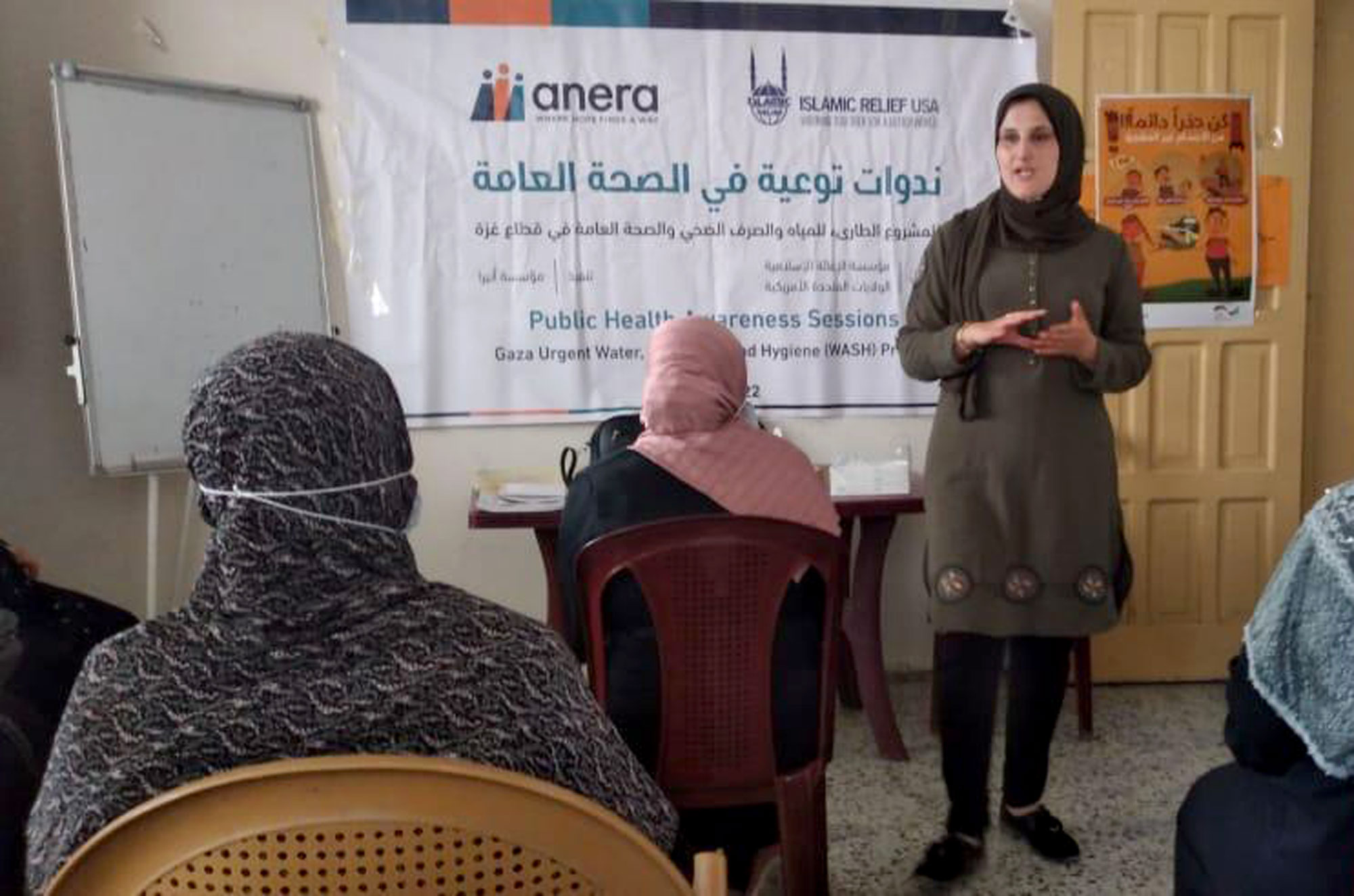 A presenter in front of a group of women.