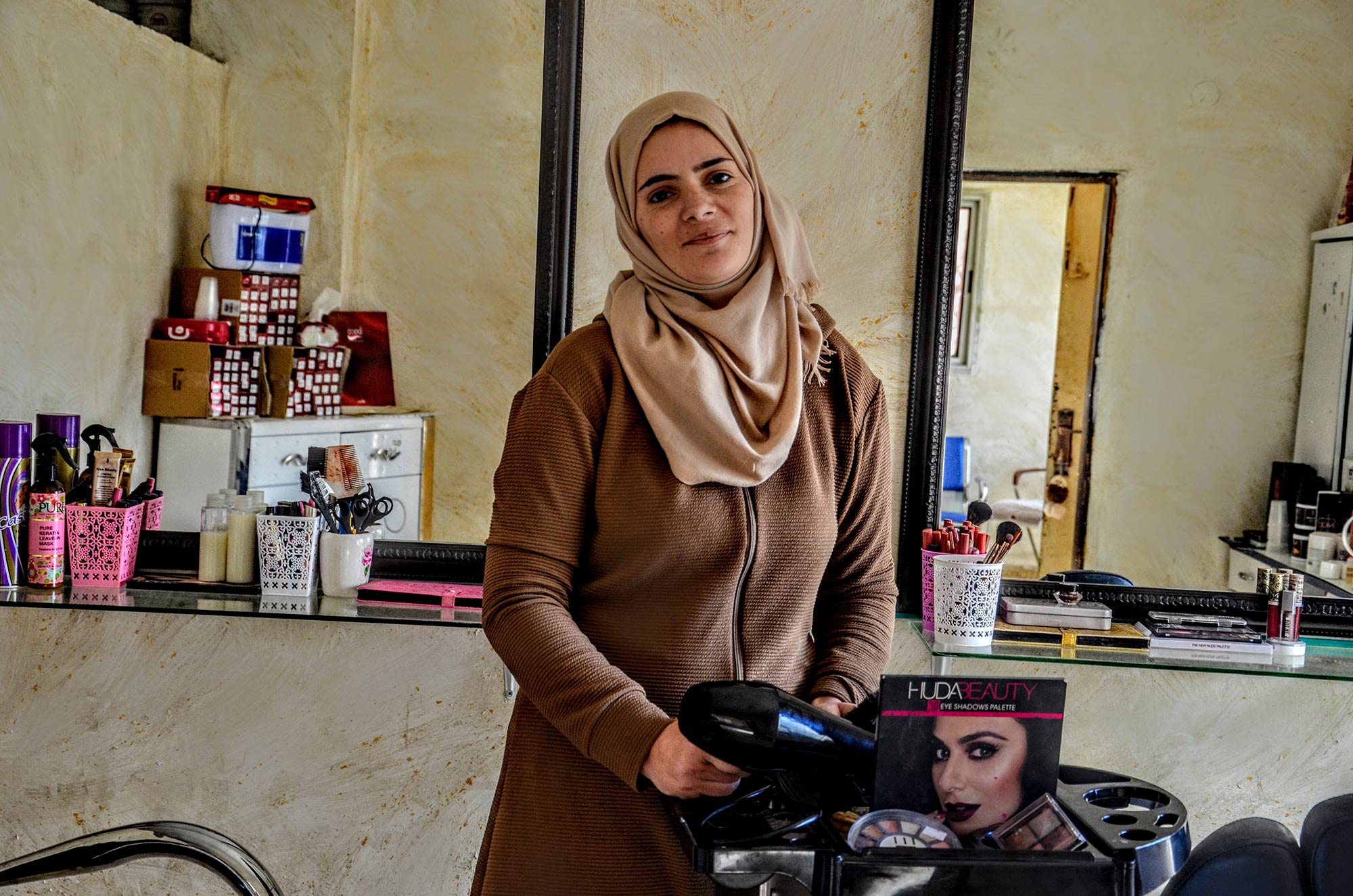 Abeer in her salon, which will provide her with income and independence through the Women Can program.