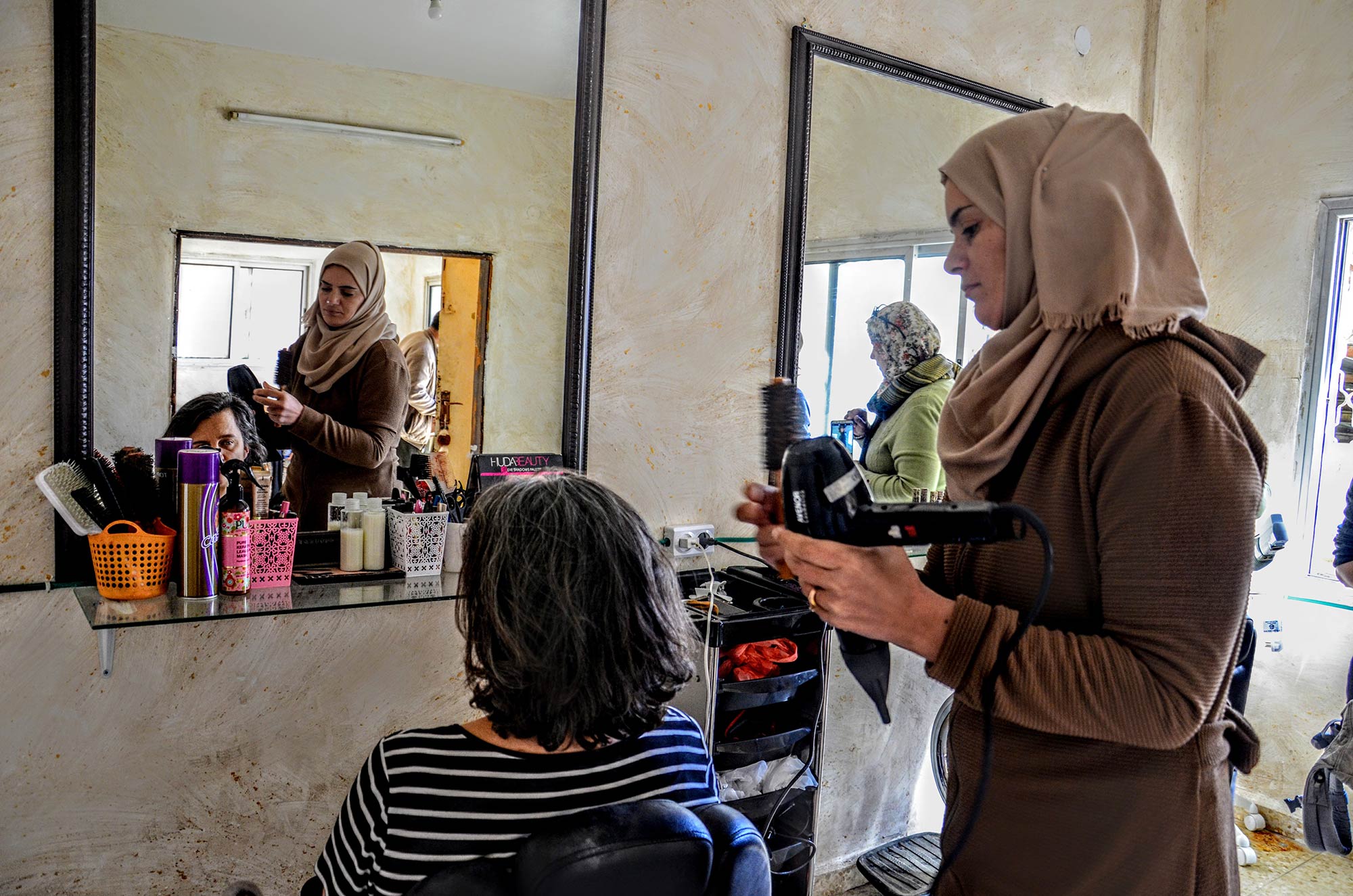 Abeer is getting down to work in her new, well-equipped salon.