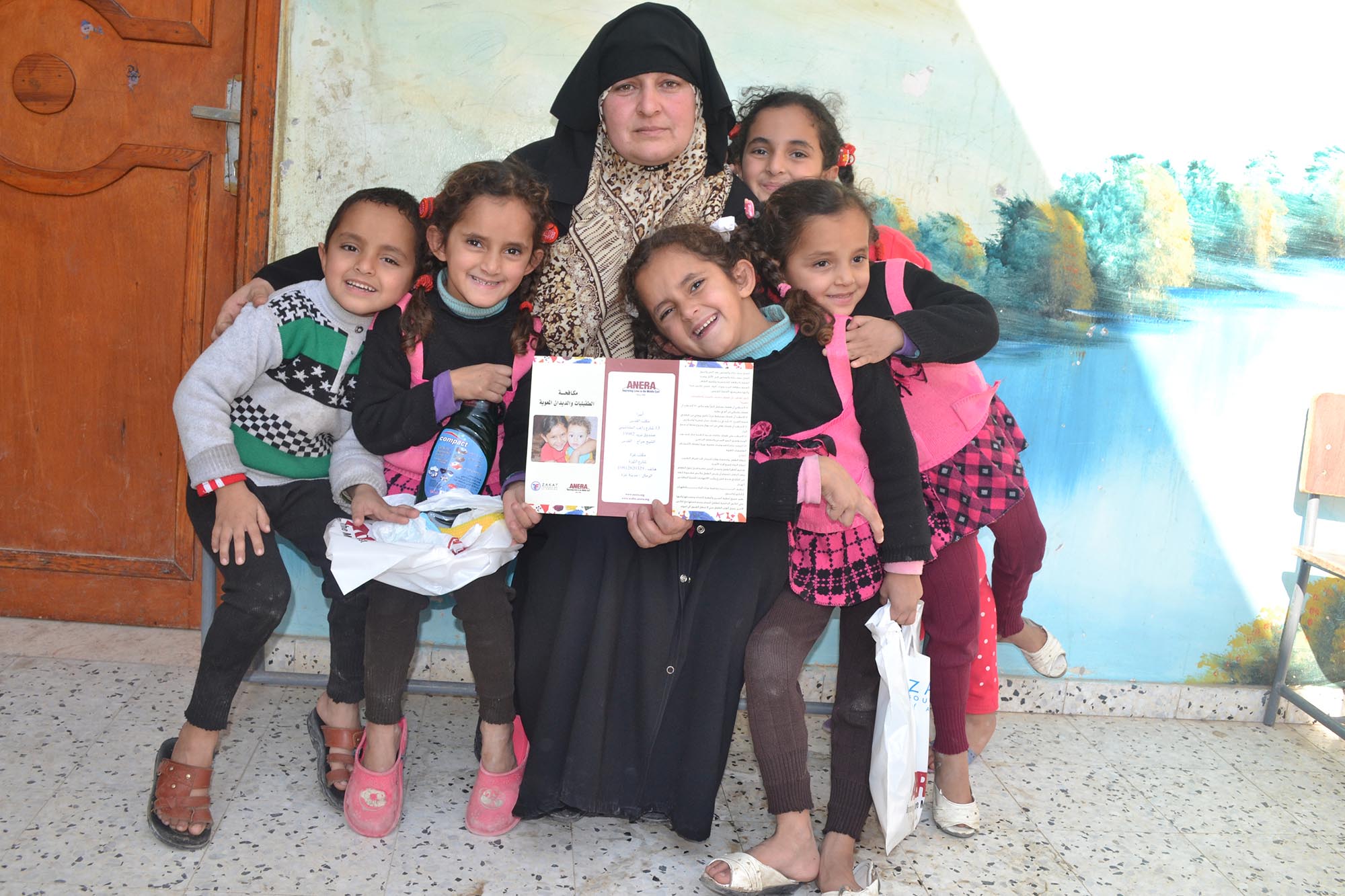 Om Ahmed and her five healthy children after parasite treatment and health education classes in Gaza.
