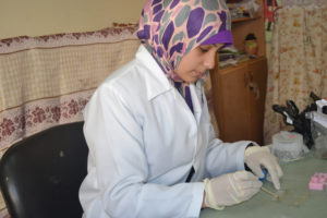 Gaza lab technician checks for parasites to determine treatments; part of Anera's parasite prevention work in Gaza.