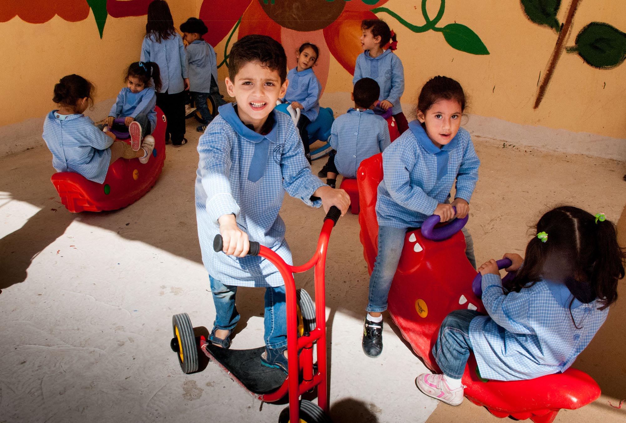 Preschoolers in Shatila Palestinian camp have fun, new equipment in their playground, thanks to Anera's renovations.