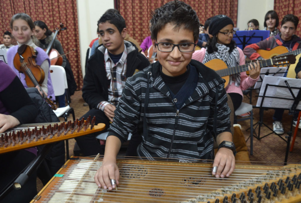 Abdel plays qanun in the Gaza Music School orchestra.