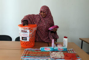 Gaza mother unpacks a dignity kit from Anera.