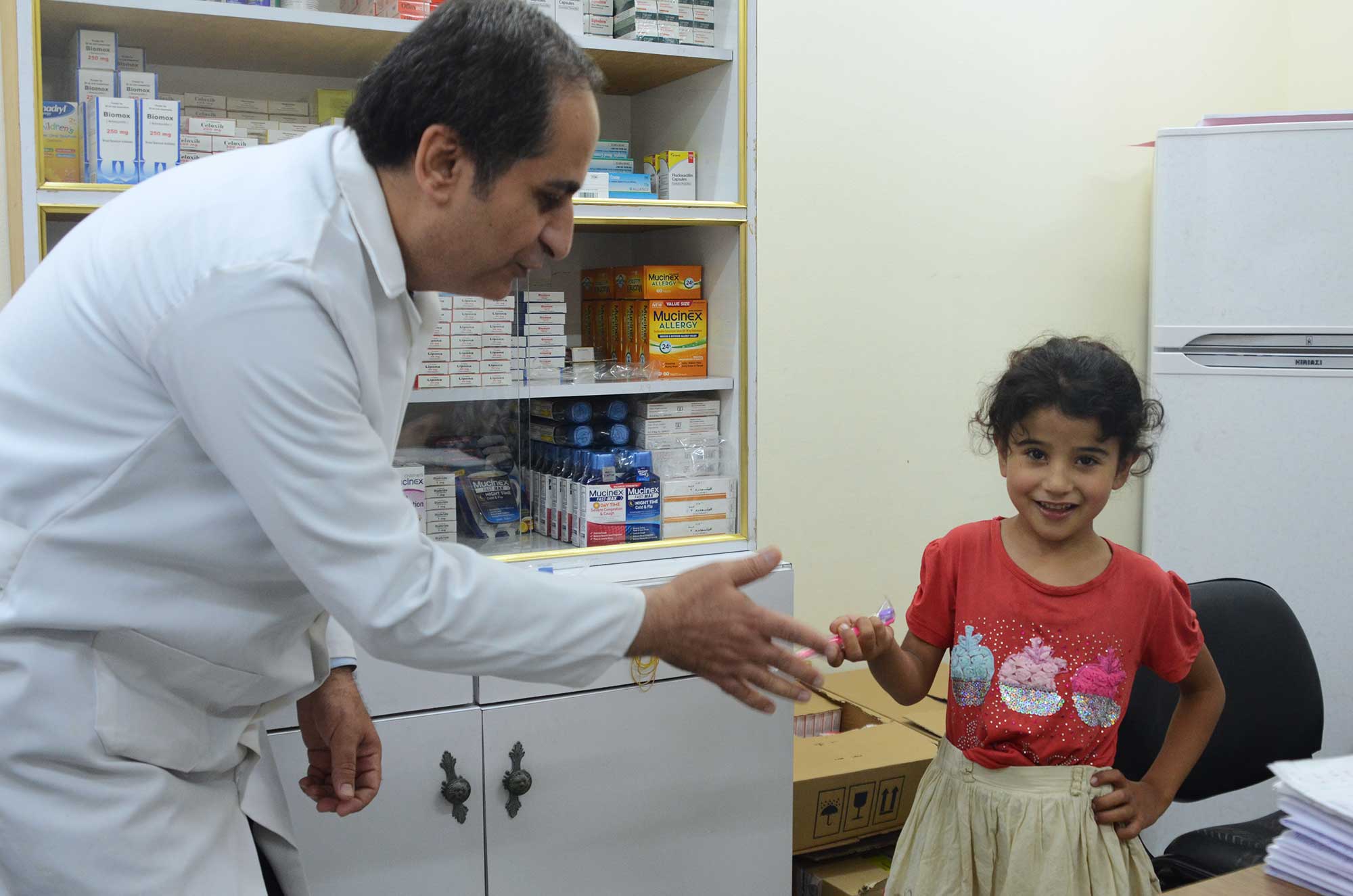 Sundus receives a pink toothbrush from her Dr. Barzaq, donated by Smile Squared and delivered by Anera