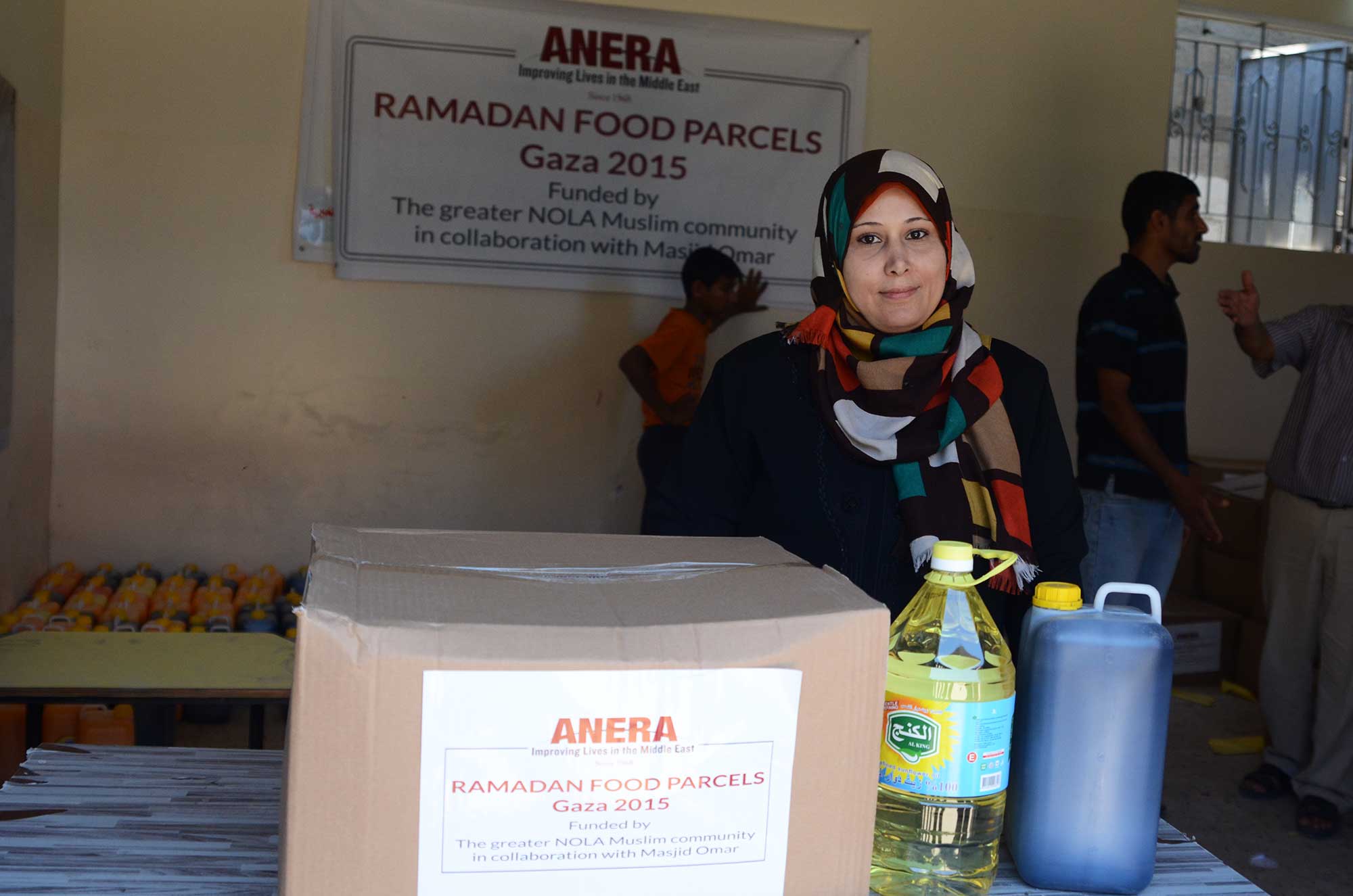 A mother stands with her food package, relieved that she can now provide meals for her family.