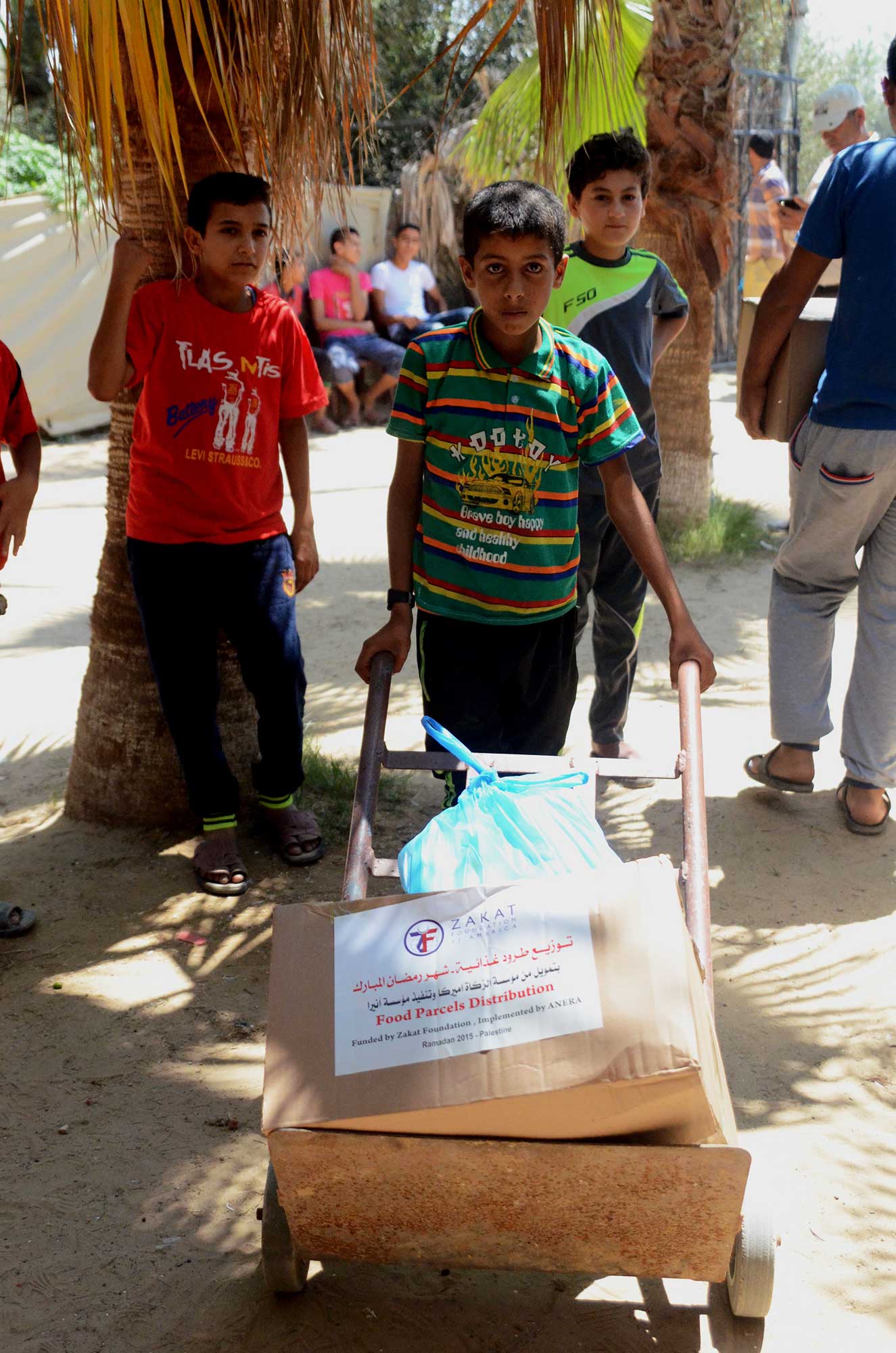 In Deir El Baleh, a young boy brought a hand cart along to help bring the Ramadan gift back to his family.