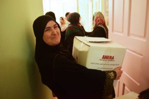 Maryam takes home an Anera food package that will help feed her family during Ramadan.