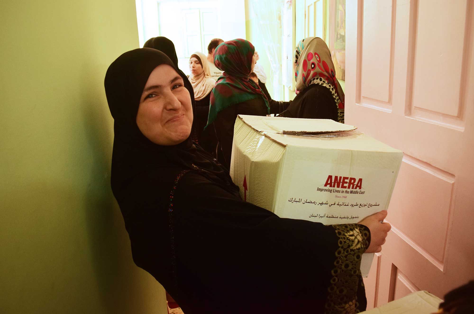 Maryam takes home an Anera food package that will help feed her family during Ramadan.