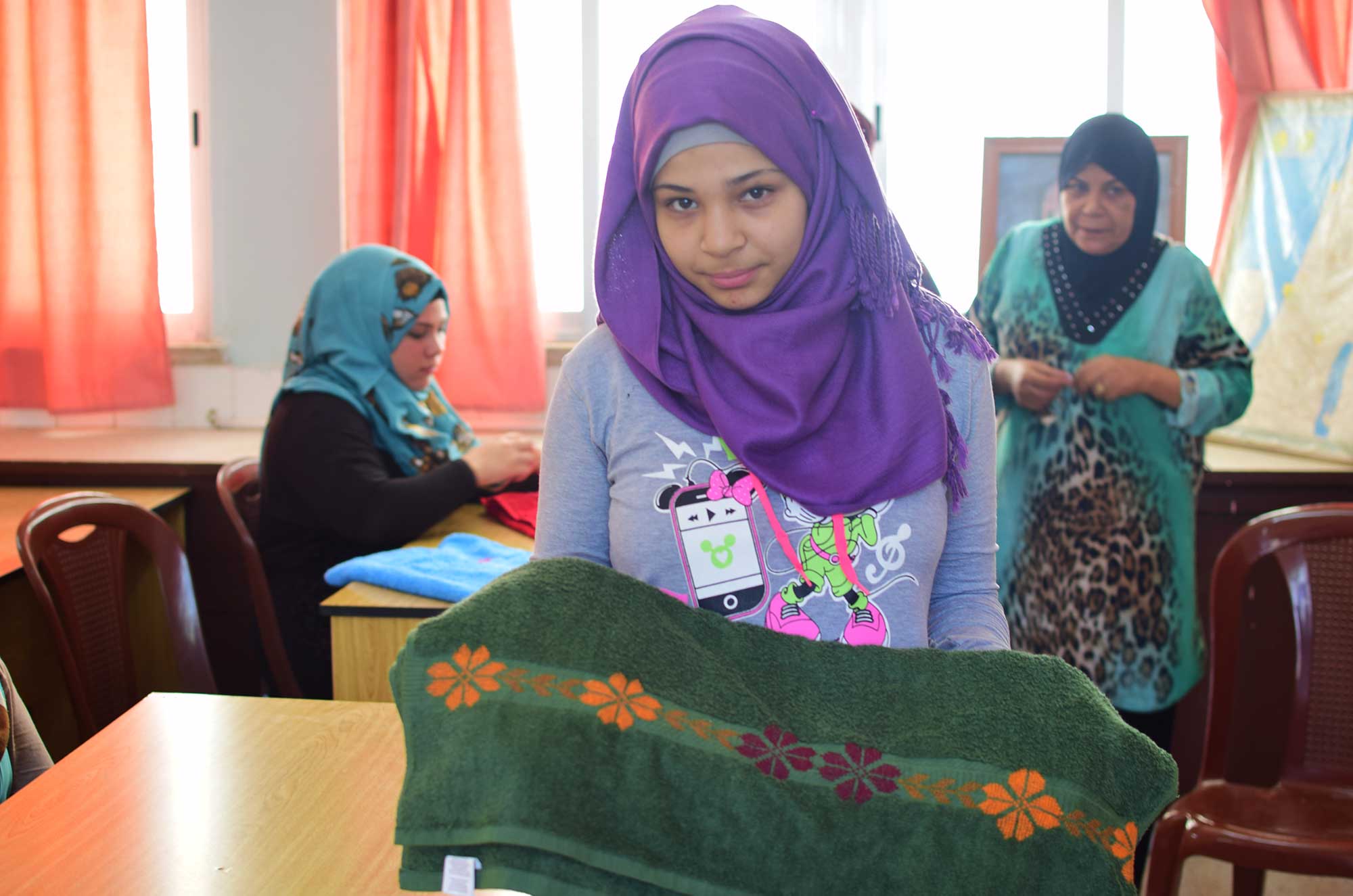 Girls in Anera's skills training course in Ein El Hilweh embroider beautiful designs on their new towels.
