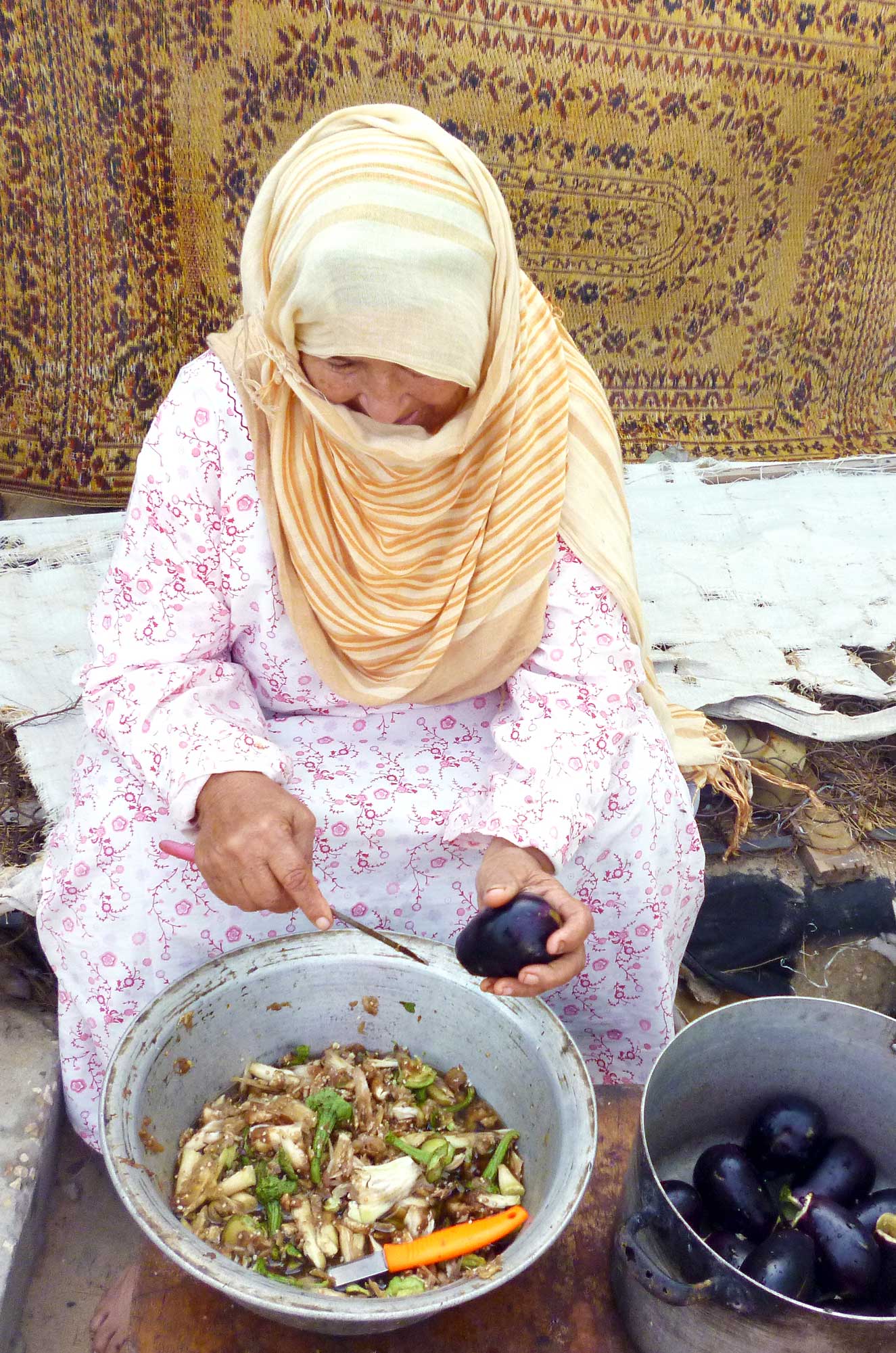 Safia hollows out each eggplant to prepare a traditional Palestinian meal.