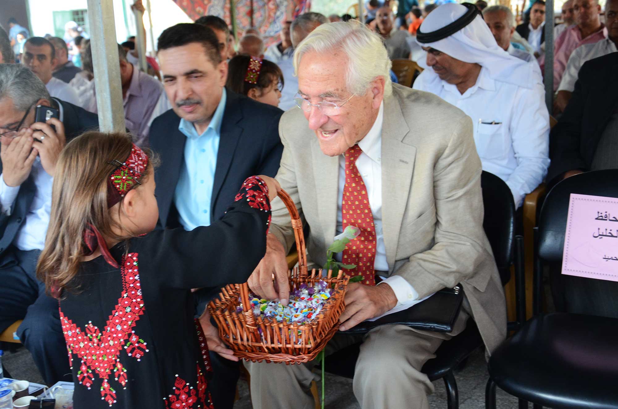 Charles Tarazi meets one of the young girls who will be attending Al Majd preschool.