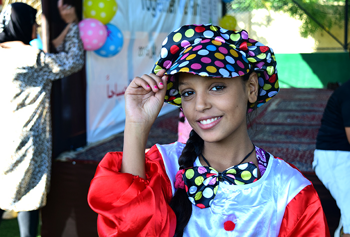 Dressing up in a fun costume, a young girl partakes in a theater performance.