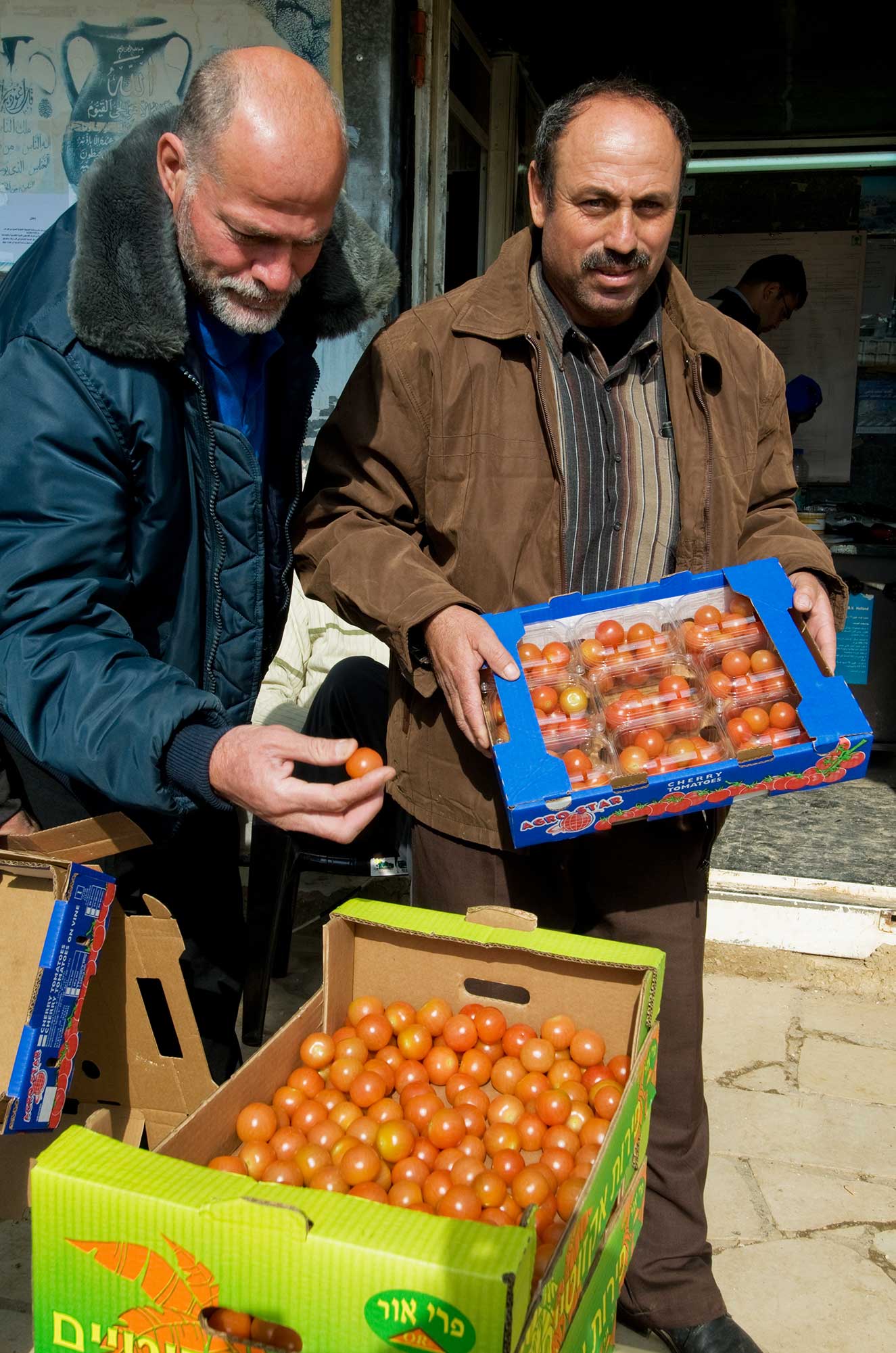 Farmers sell the tomatoes they harvested at the local market.
