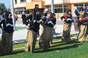 Teens have fun participating in a sack race on Anera's Open Sports Day for Nahr El Bared.