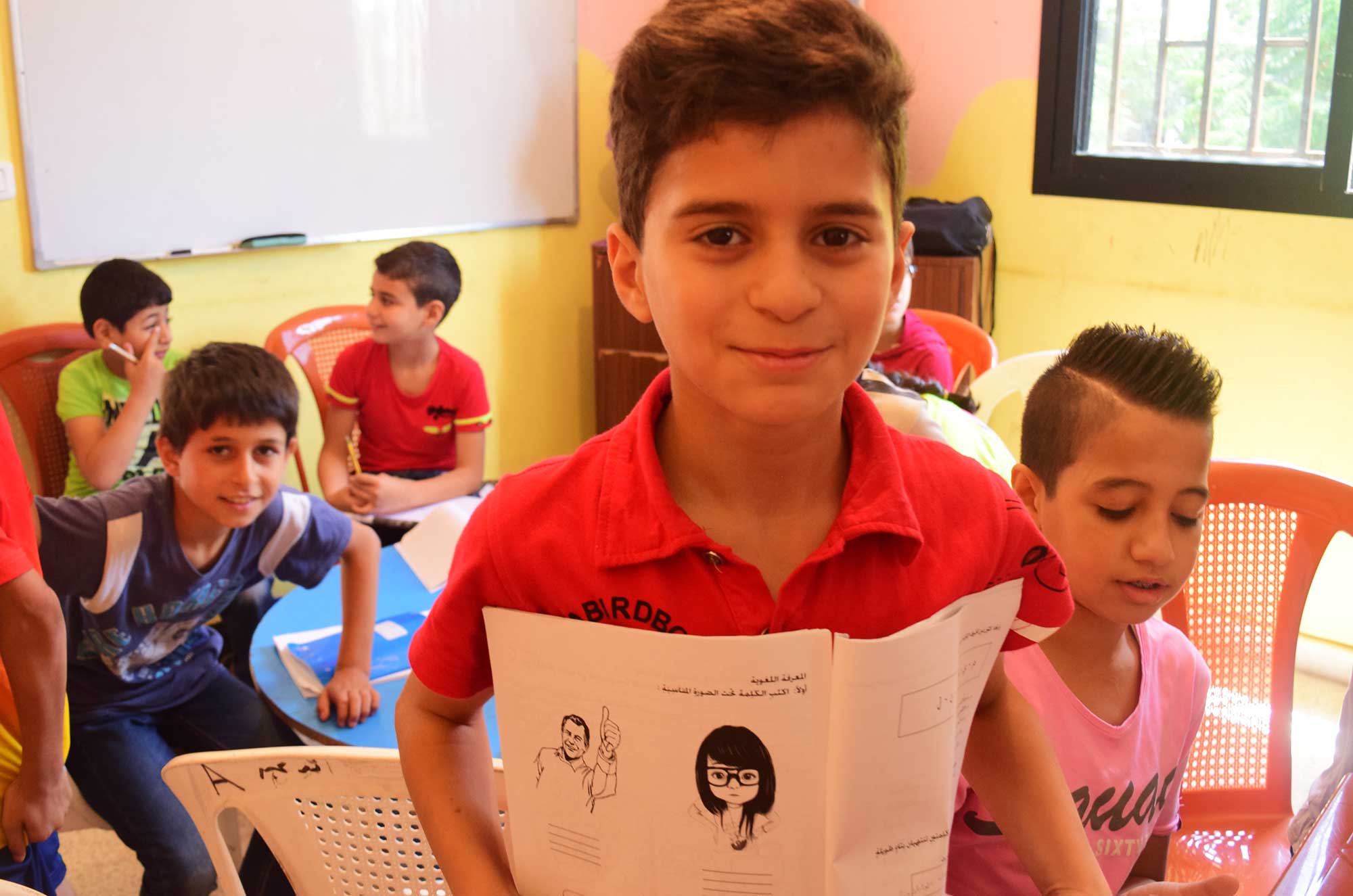 Students in Anera’s basic education classes work on their Arabic.