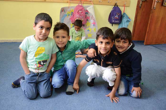 support3 Preschool children enjoy their Anera-renovated preschool in Kifl Haris, Palestine.