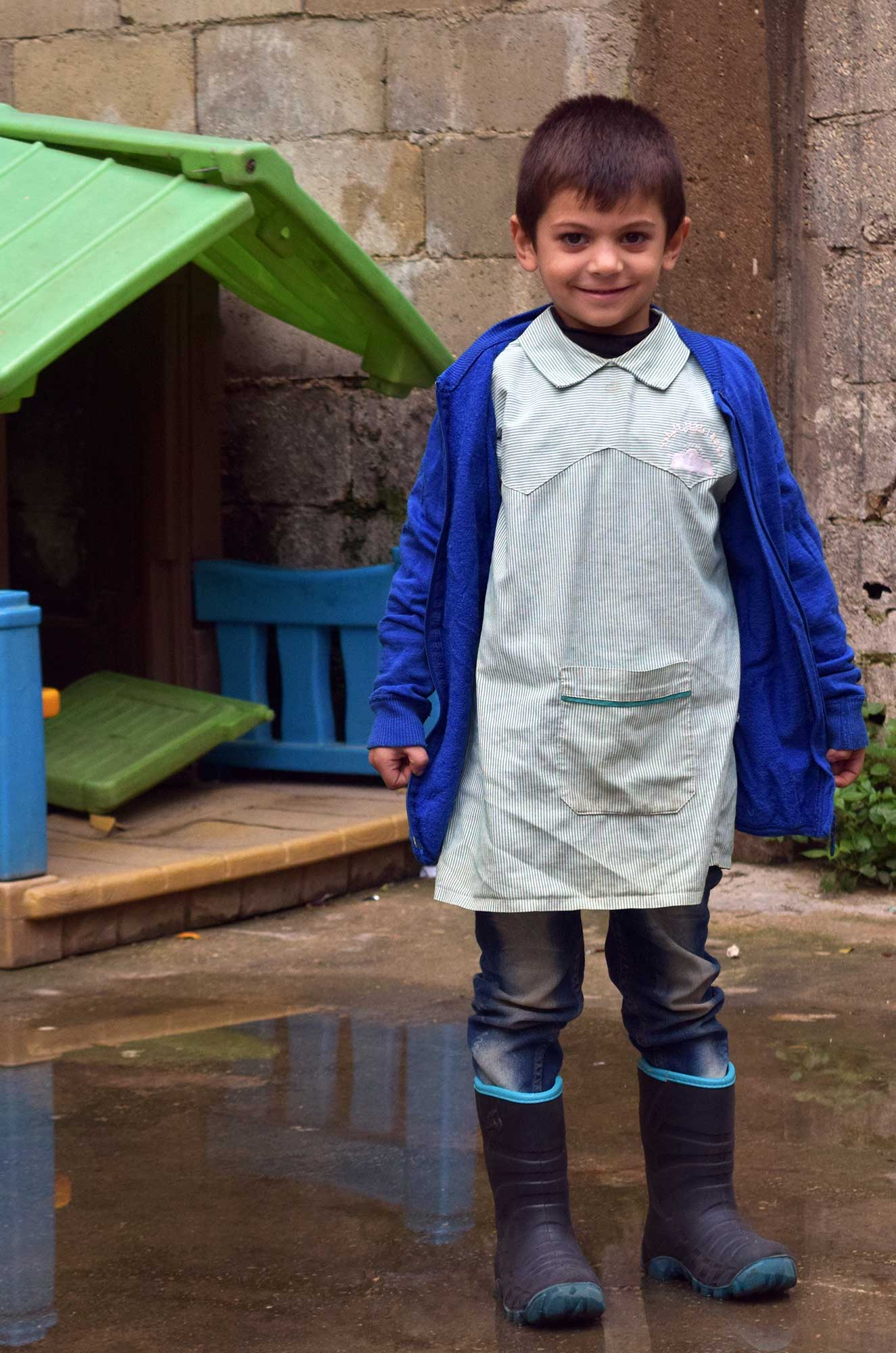 vuln2 Taha outside the Children and Youth Center in Nahr El Bared, wearing his new boots.