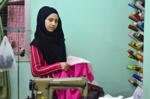 14-year-old Hanine from Homs, Syria is taking Anera's sewing class and just receive a new sewing kit.