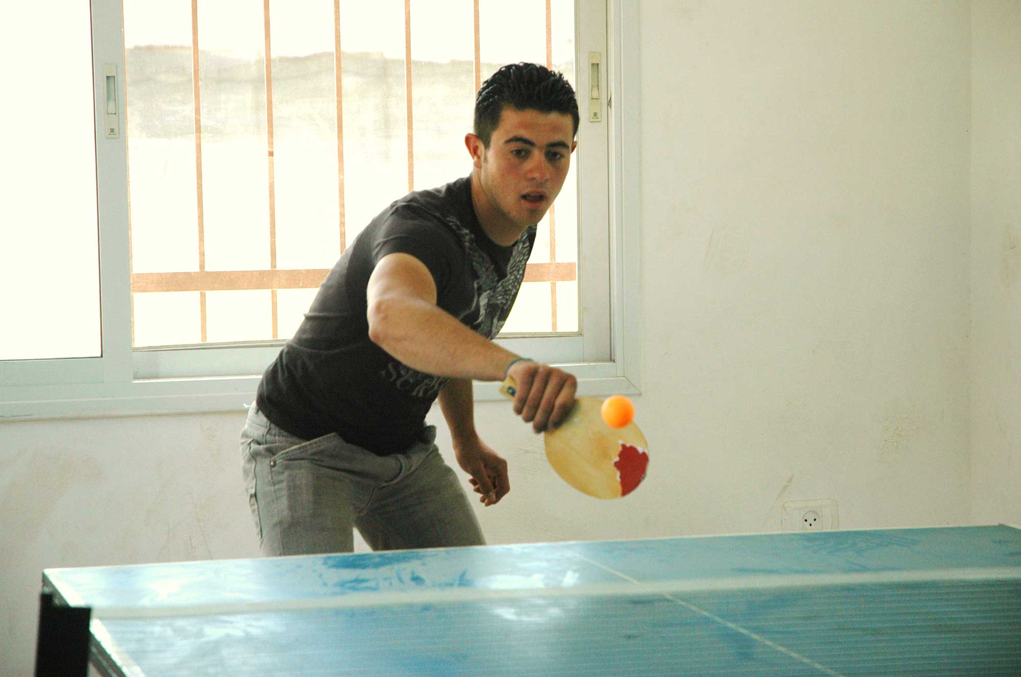 qal1 A Palestinian teenager plays table tennis at the new community center in Jayyus in 2009.