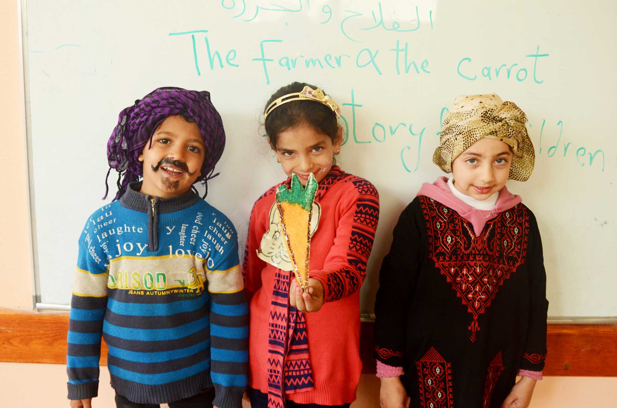 Children dress up as the characters in a story about a farmer and a carrot.