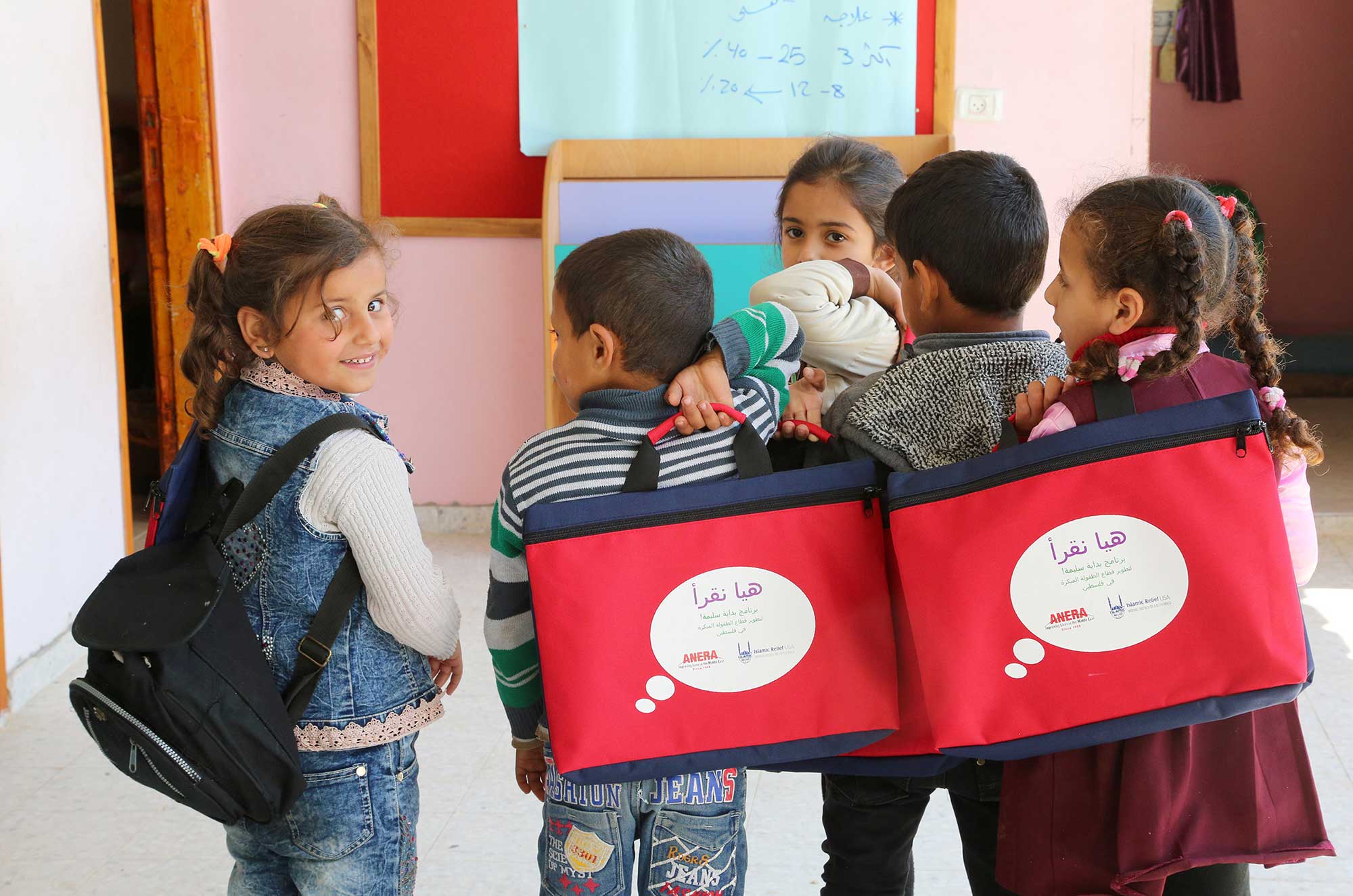 Children at an Anera partner preschool in Ajyal al Tahreer, Gaza receive new reading materials provided by Anera and Islamic Relief USA.