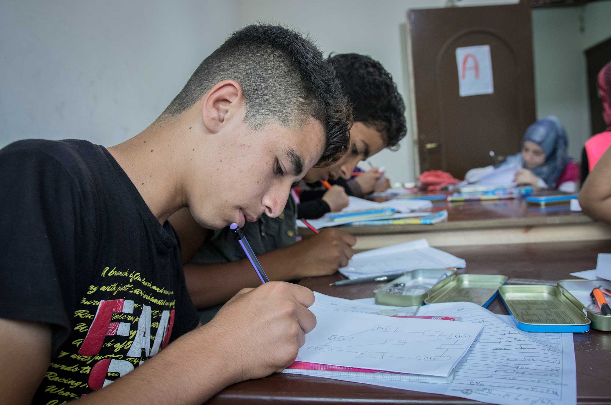 Hassan is a 15-year-old Syrian teen who has been in Bhannine for four years. He is not in formal schooling, and gets his education solely from these courses held by Anera. "I come here to learn what I missed in school," he says.