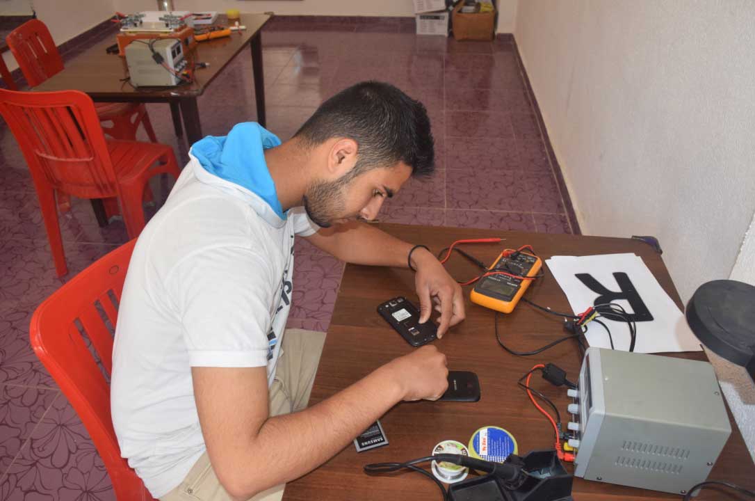 ref2 Fares, who fled to Lebanon from Aleppo two years ago, is gaining practical job skills in Anera's phone maintenance course.