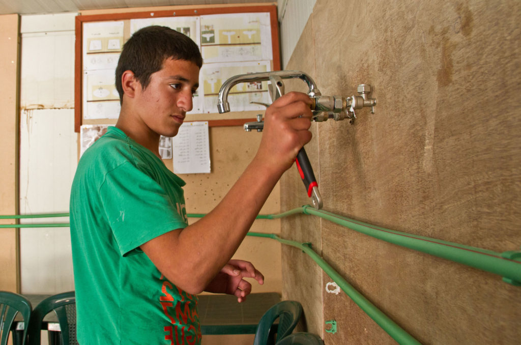 A student does Anera training in Lebanon to become a plumber.