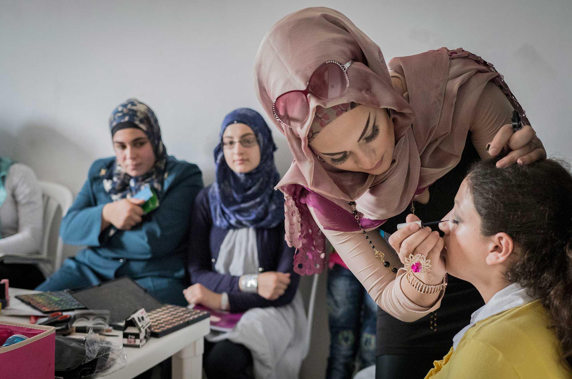 Ms. Fatima teaches a makeup course to Syrian refugees looking for jobs in Lebanon.