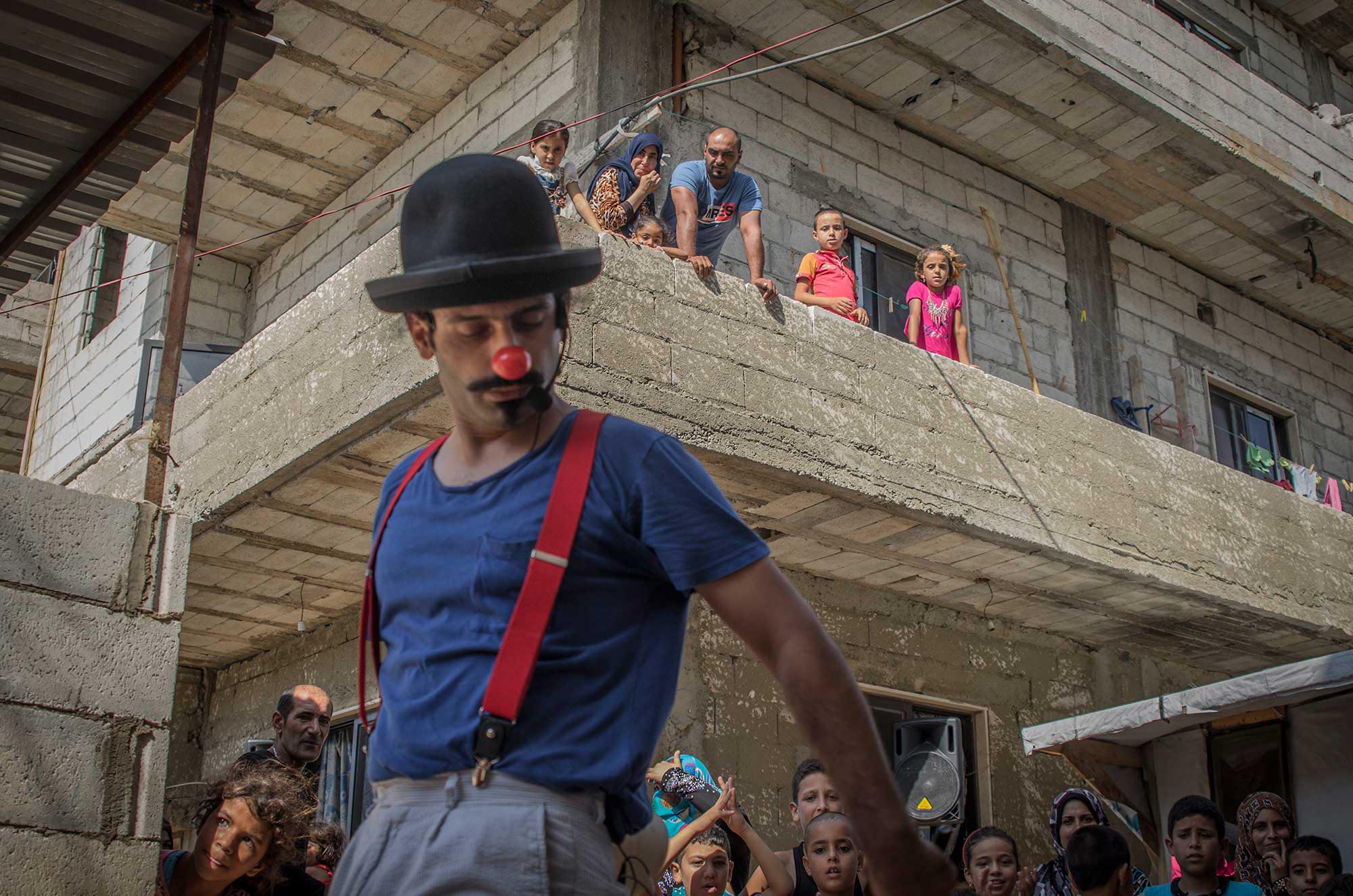 teeth Hadi Deaibes performs for the children in the audience -- as well as their families watching from above.