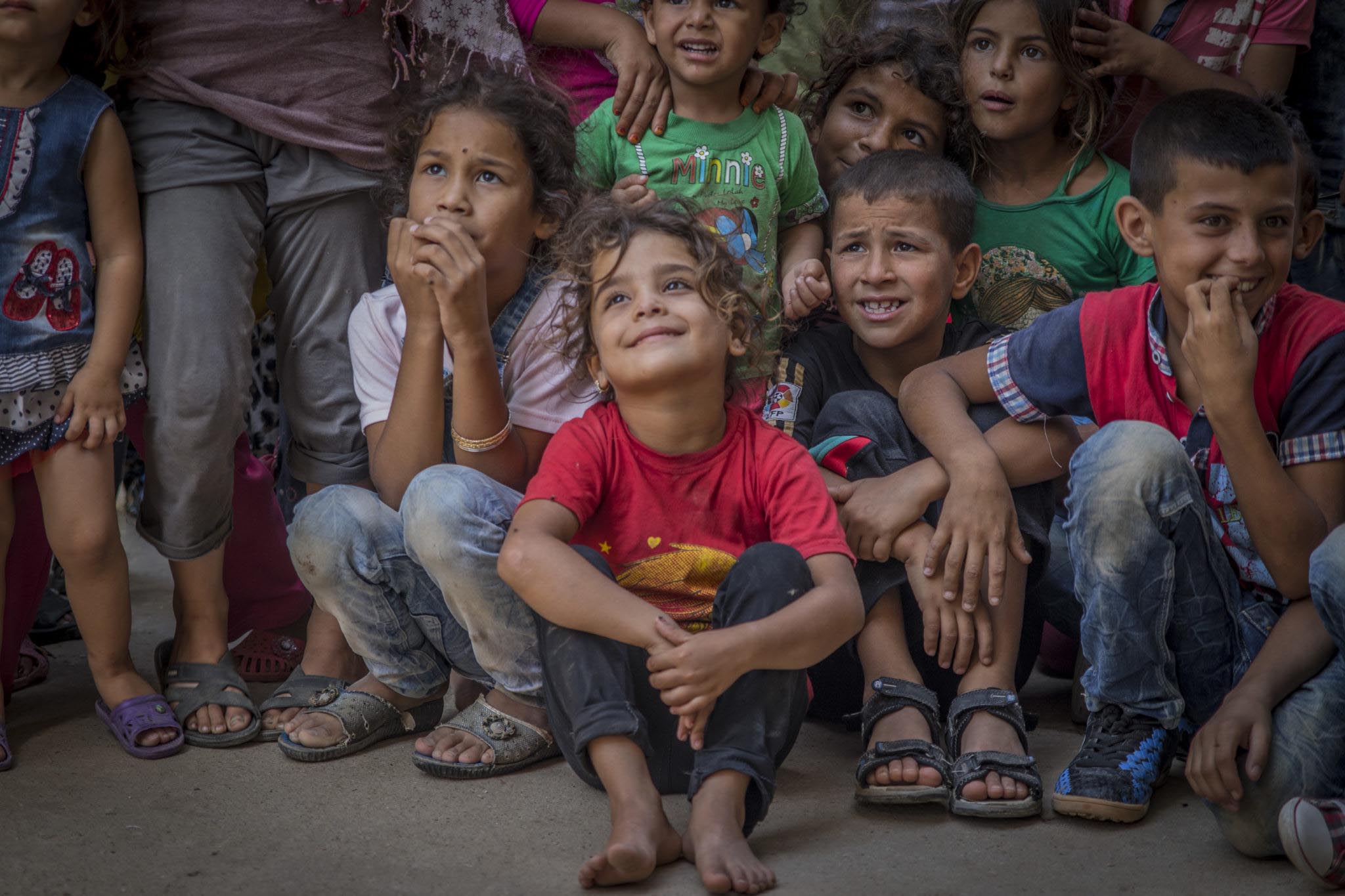 Syrian children watch a circus show teaching them dental care.
