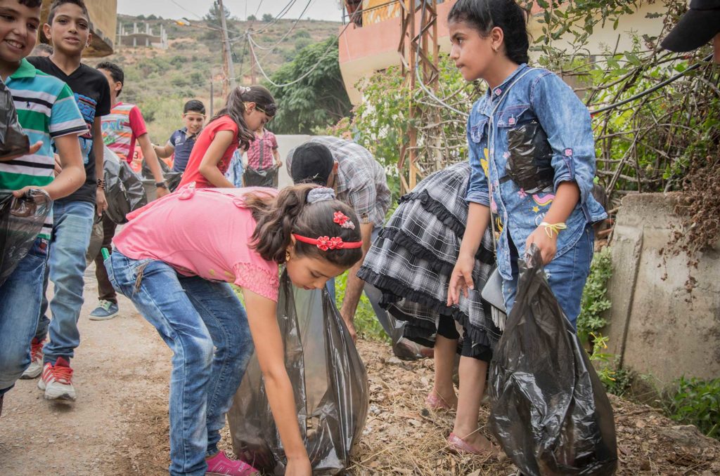 Youth volunteers clean up their neighborhoods to help improve the environment in Lebanon.