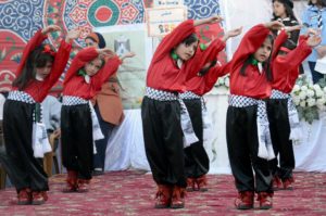 Palestinian girls dance at the Al Majd Preschool inauguration in the West Bank