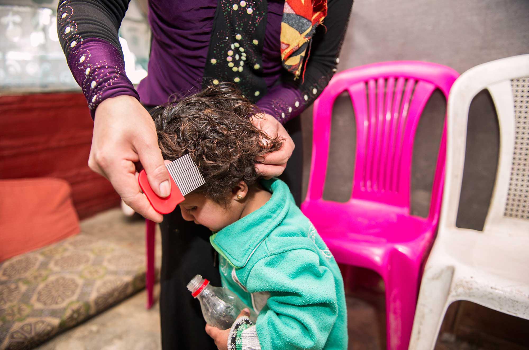 Syrian and Palestinian refugee children get lice treatment and training in Lebanon.