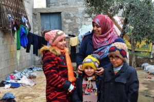 A family prepares for winter in Gaza with clothes from an Anera voucher program.