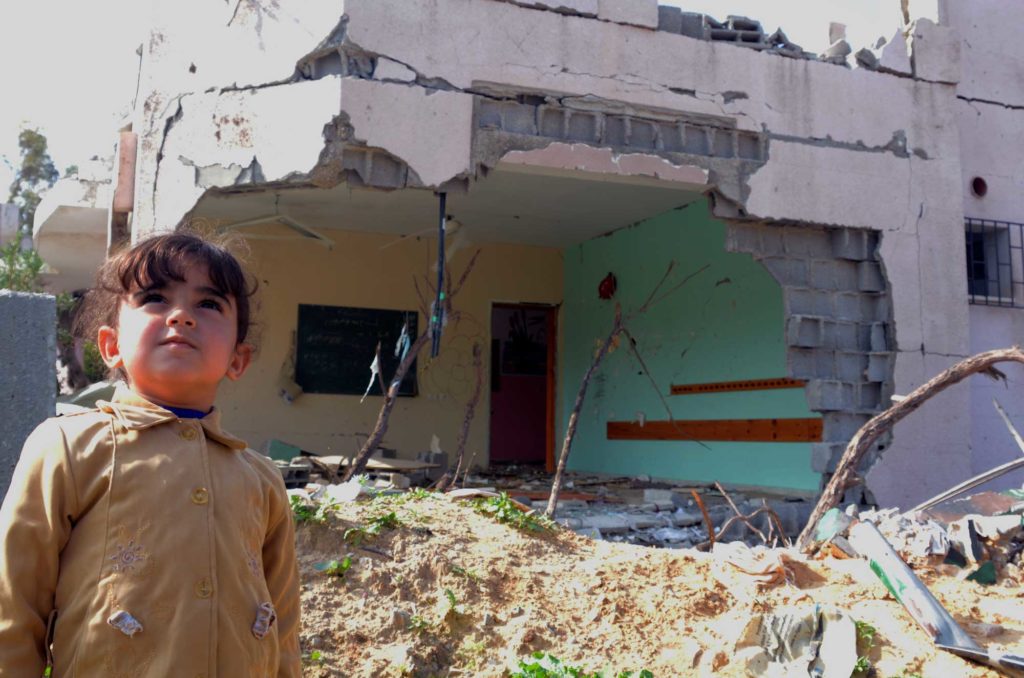Preschooler in Gaza at her destroyed school, benefits from Anera's psychosocial work