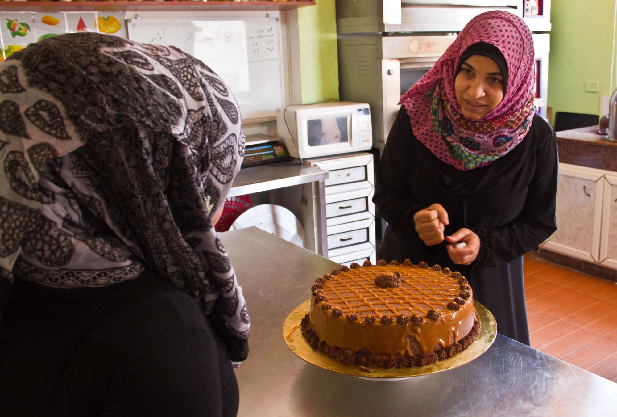 Pastry students work on a cake at the Women’s Program Center in Nahr El Bared.