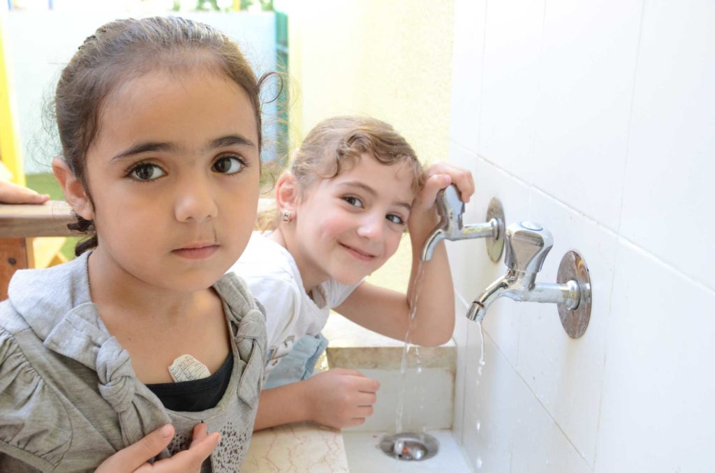 Preschoolers at their new sink, installed by Anera as part of its early childhood development program.
