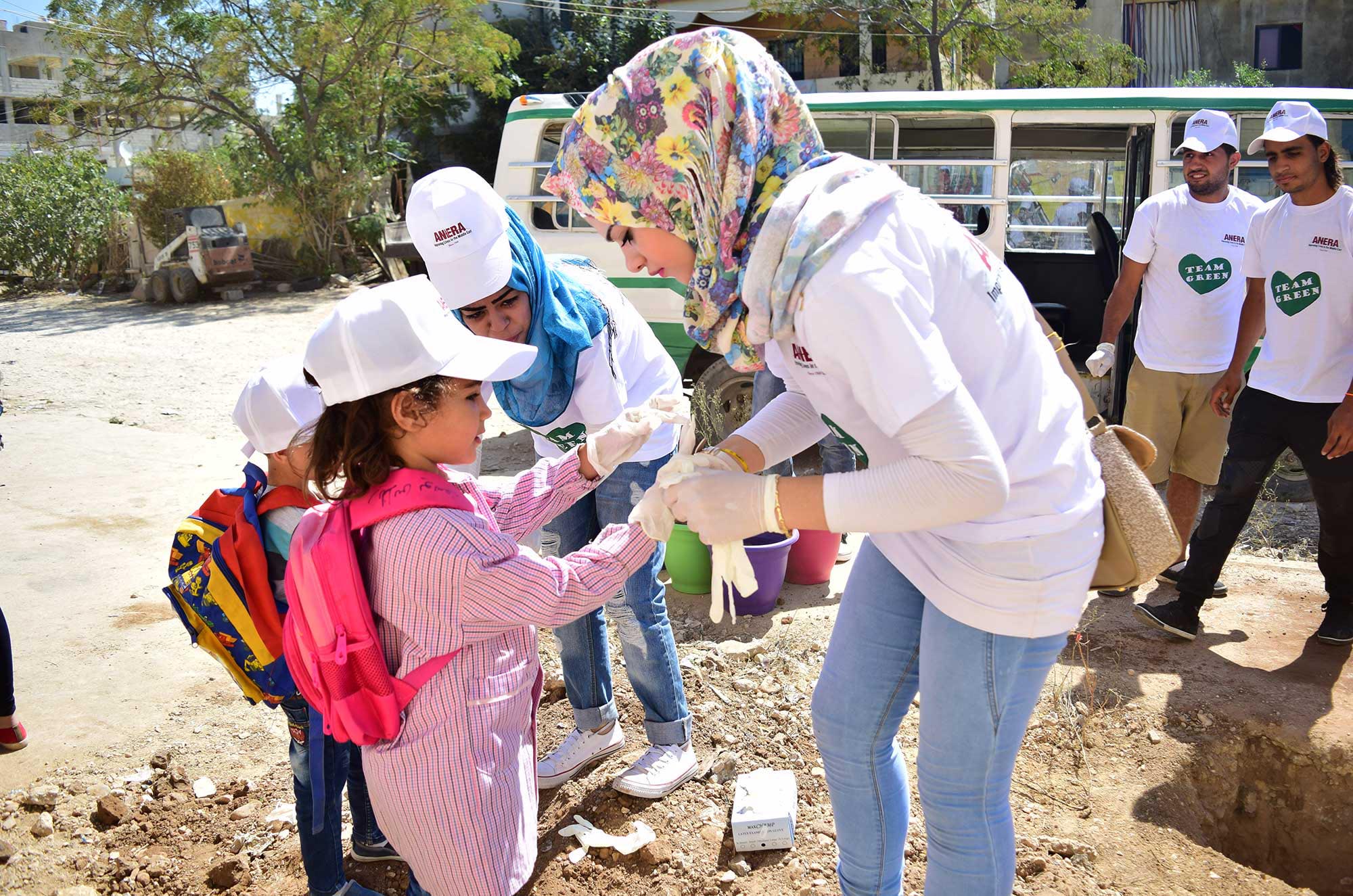 Youth volunteers in Nahr El Bared refugee camp combat the Lebanon trash crisis by collecting and sorting waste, planting trees